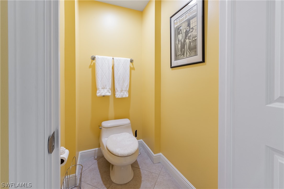 2743 First Street, Unit 602 Fort Myers, FL 33916 - Photo 19 of 38 a white toilet sitting next to a blue wall