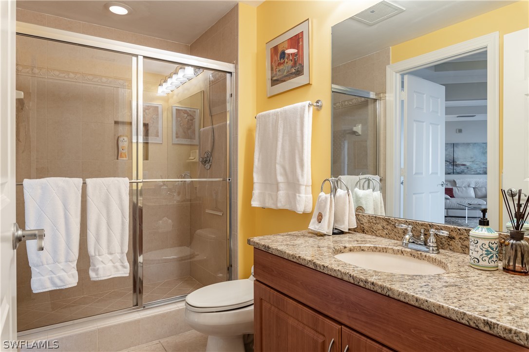 2743 First Street, Unit 602 Fort Myers, FL 33916 - Photo 28 of 38 a bathroom with a granite countertop sink toilet and shower