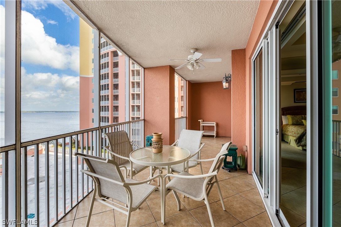 2743 First Street, Unit 602 Fort Myers, FL 33916 - Photo 29 of 38 a view of a balcony dining area with furniture and a window