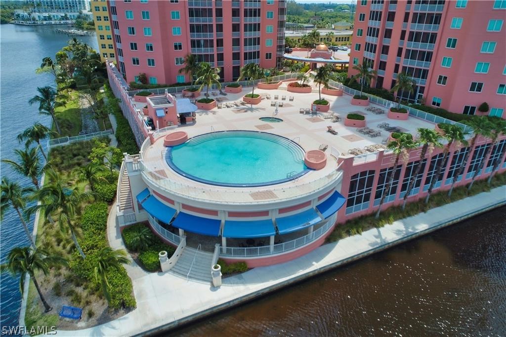 2743 First Street, Unit 602 Fort Myers, FL 33916 - Photo 32 of 38 a view of a swimming pool with a lounge chairs