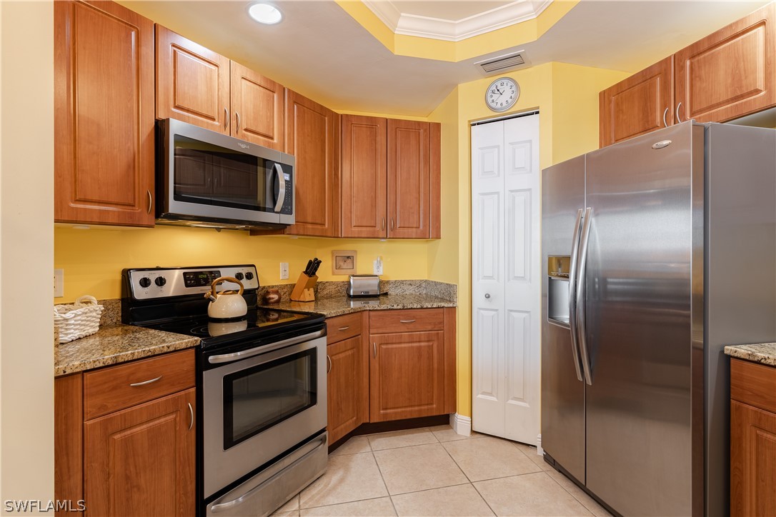 2743 First Street, Unit 602 Fort Myers, FL 33916 - Photo 6 of 38 a kitchen with stainless steel appliances granite countertop a stove a refrigerator and a microwave