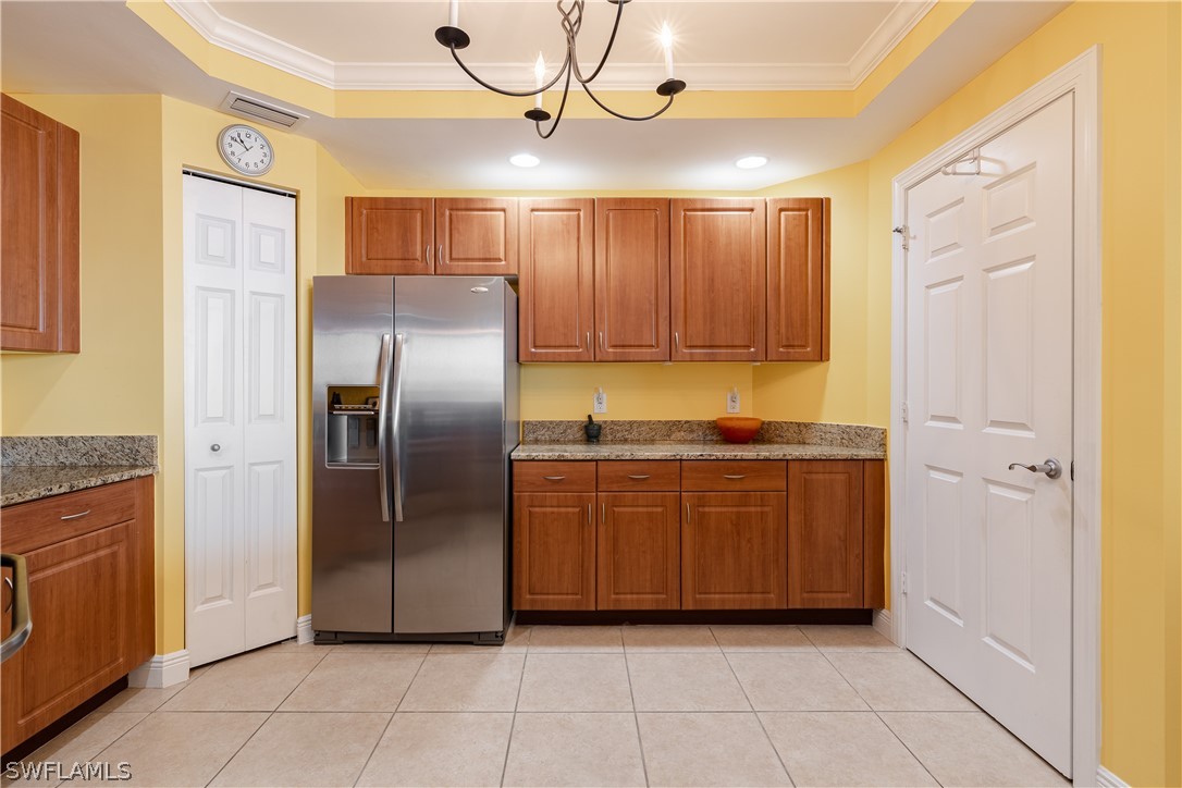 2743 First Street, Unit 602 Fort Myers, FL 33916 - Photo 7 of 38 a kitchen with granite countertop a refrigerator and a sink