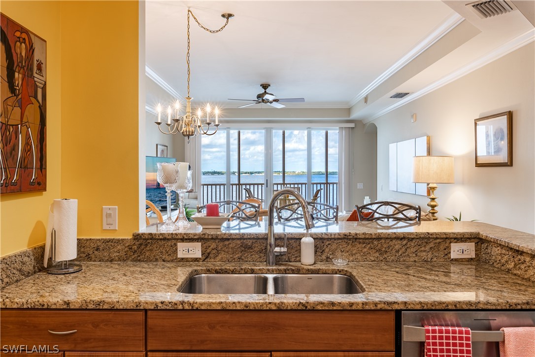 2743 First Street, Unit 602 Fort Myers, FL 33916 - Photo 8 of 38 a view of a kitchen counter top a sink and chandelier