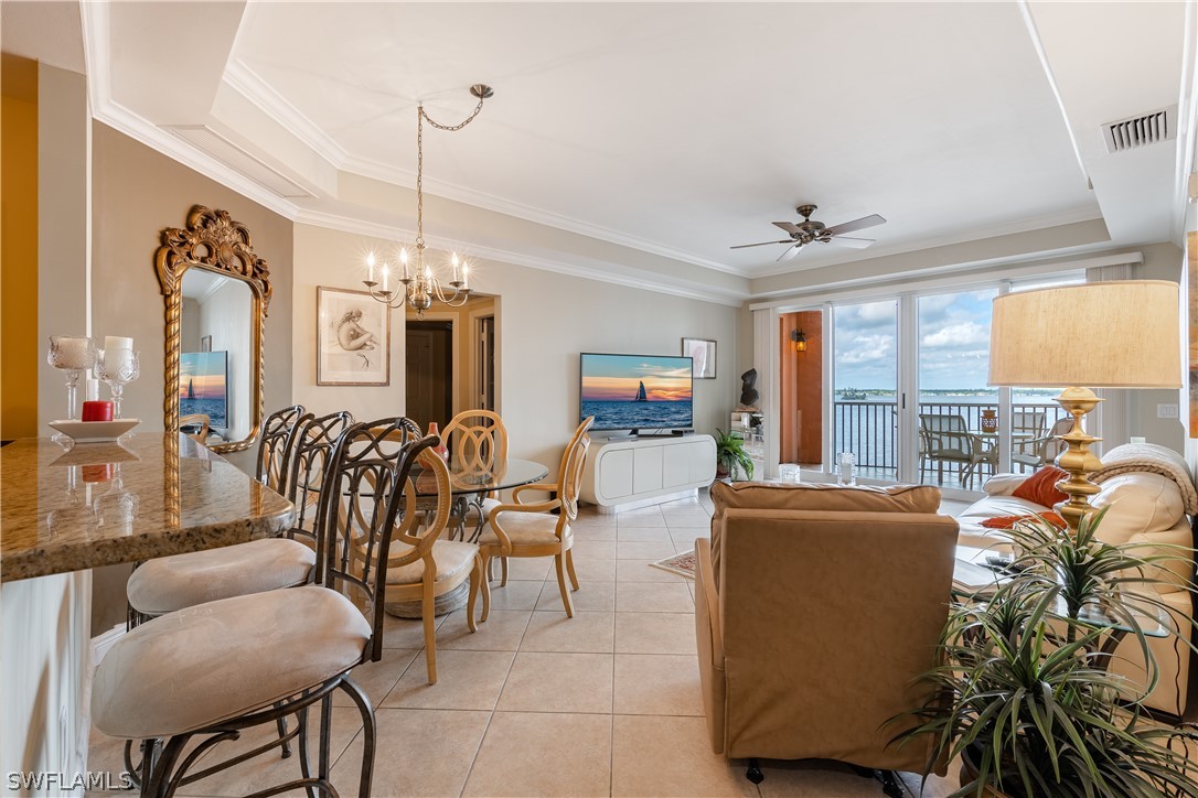 2743 First Street, Unit 602 Fort Myers, FL 33916 - Photo 9 of 38 a dining room filled with furniture and a chandelier