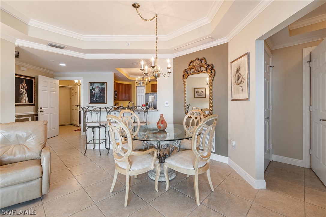2743 First Street, Unit 602 Fort Myers, FL 33916 - Photo 10 of 38 a view of a dining room with furniture and a chandelier