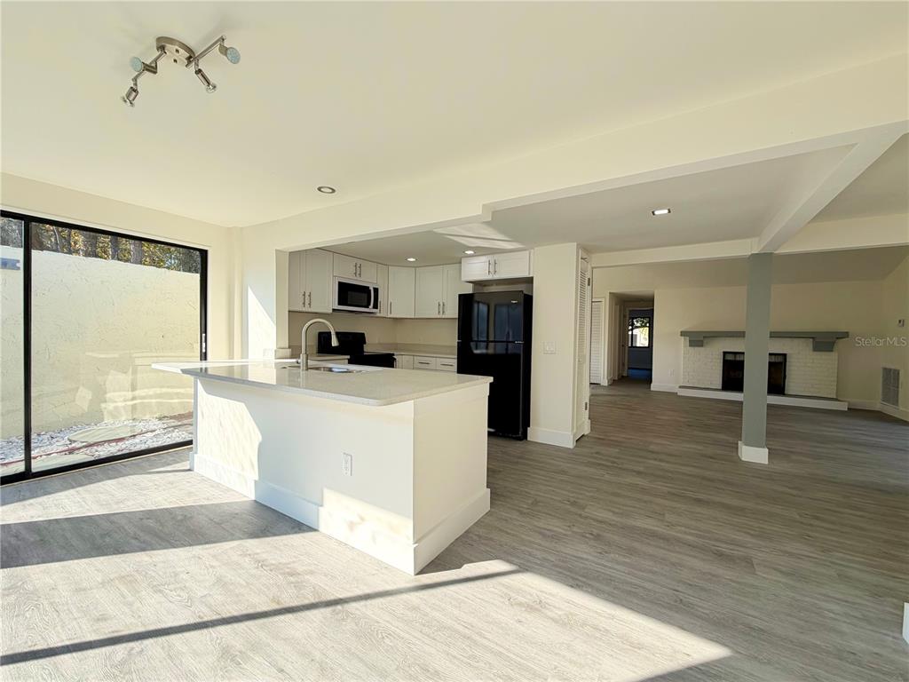 7314 Patio Row Hudson, FL 34667 - Photo 6 of 17 a view of kitchen with refrigerator and wooden floor