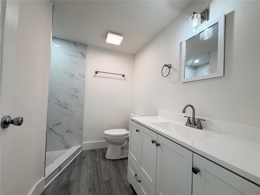 7314 Patio Row Hudson, FL 34667 - Photo 10 of 17 a bathroom with a toilet a sink and mirror
