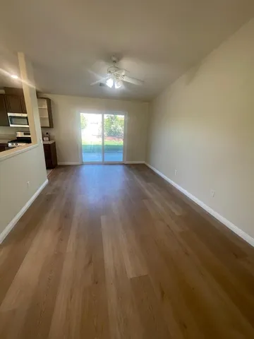 wooden floor in an empty room with a window
