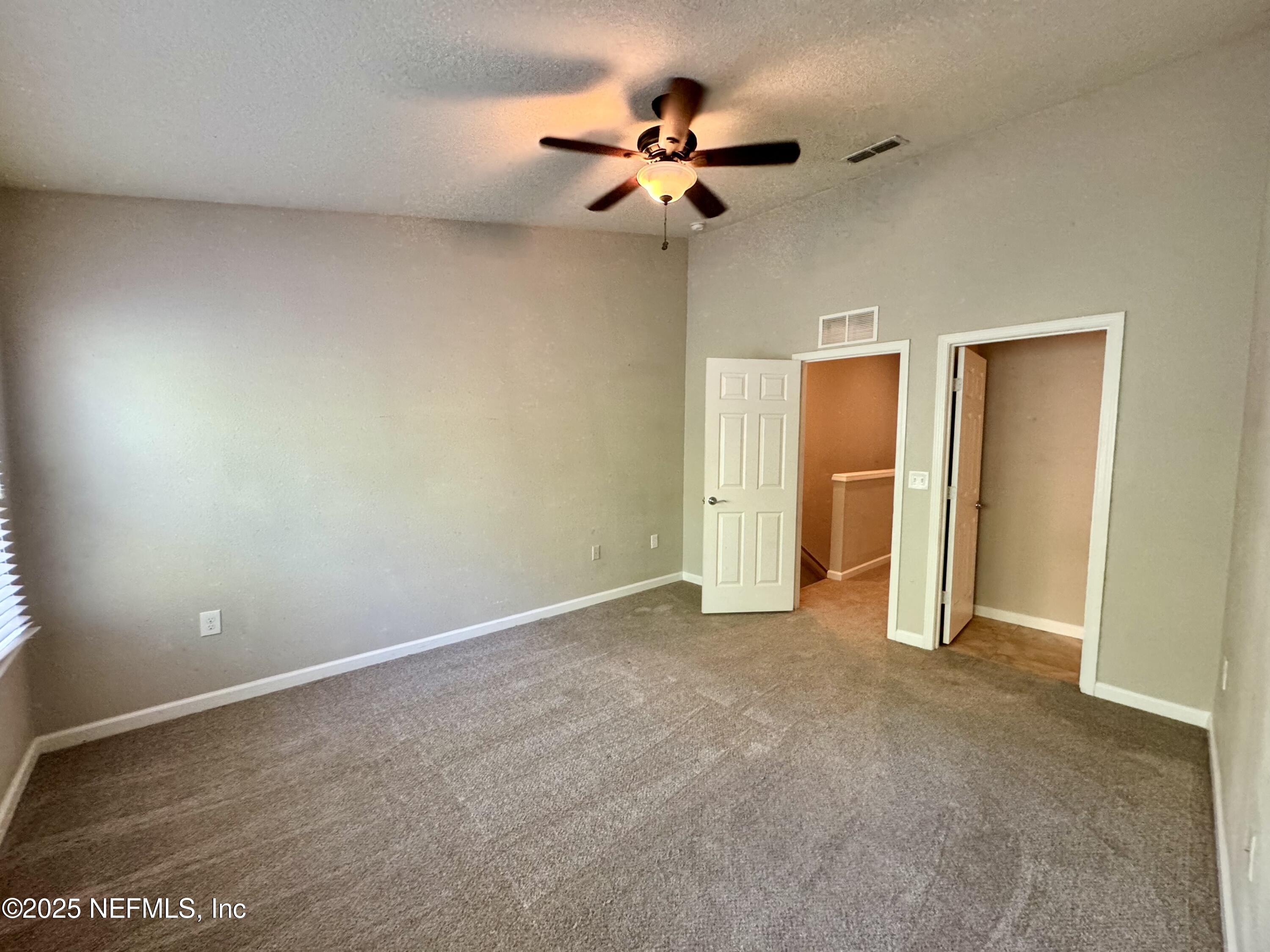 6839 Roundleaf Drive Jacksonville, FL 32258 - Photo 12 of 30 an empty room with closet and a ceiling fan