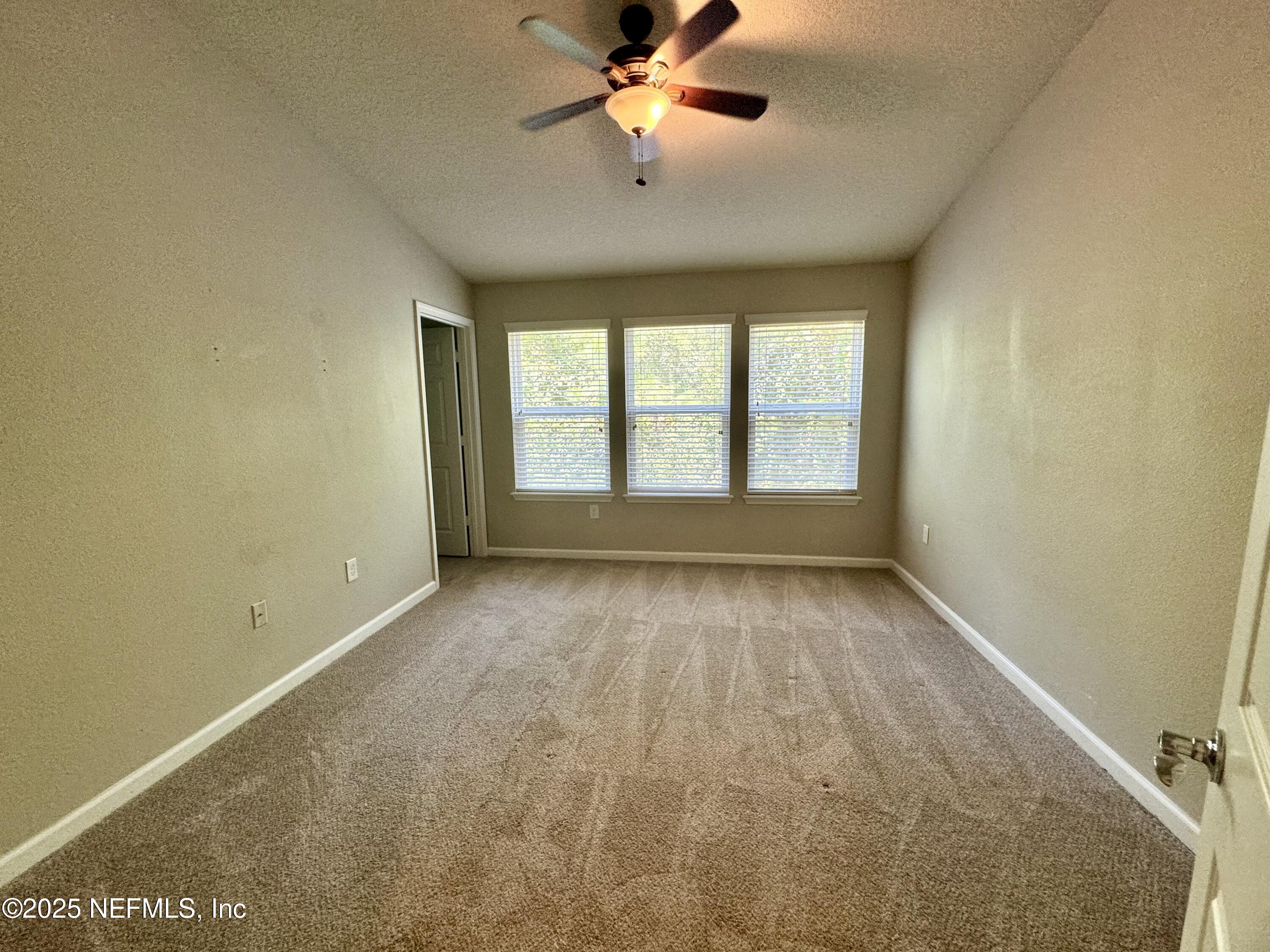 6839 Roundleaf Drive Jacksonville, FL 32258 - Photo 13 of 30 wooden floor in an empty room with a window