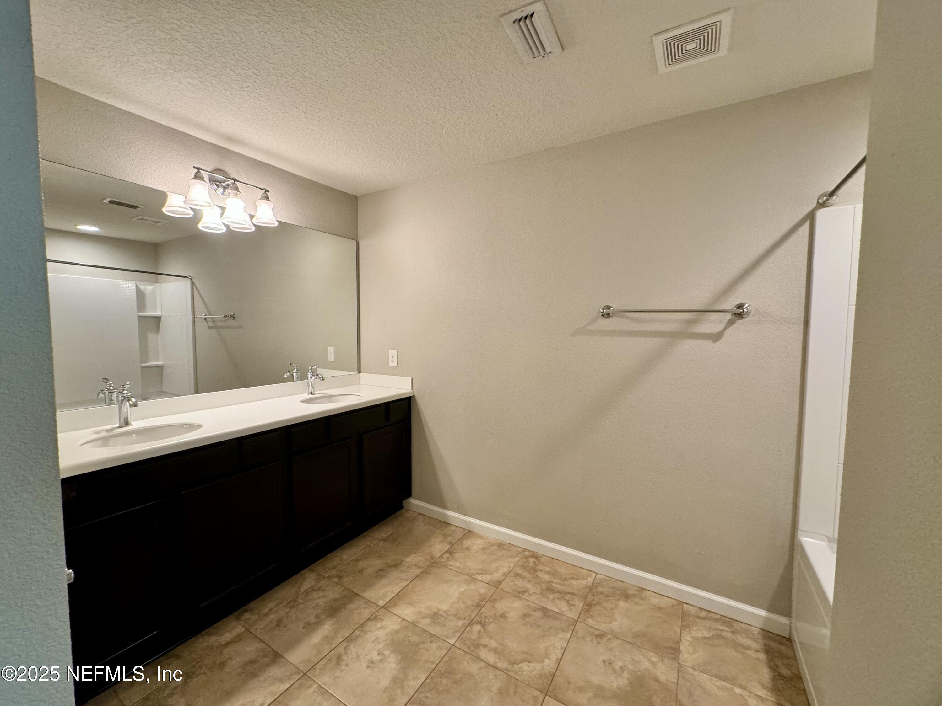 6839 Roundleaf Drive Jacksonville, FL 32258 - Photo 15 of 30 a bathroom with a sink vanity and a mirror