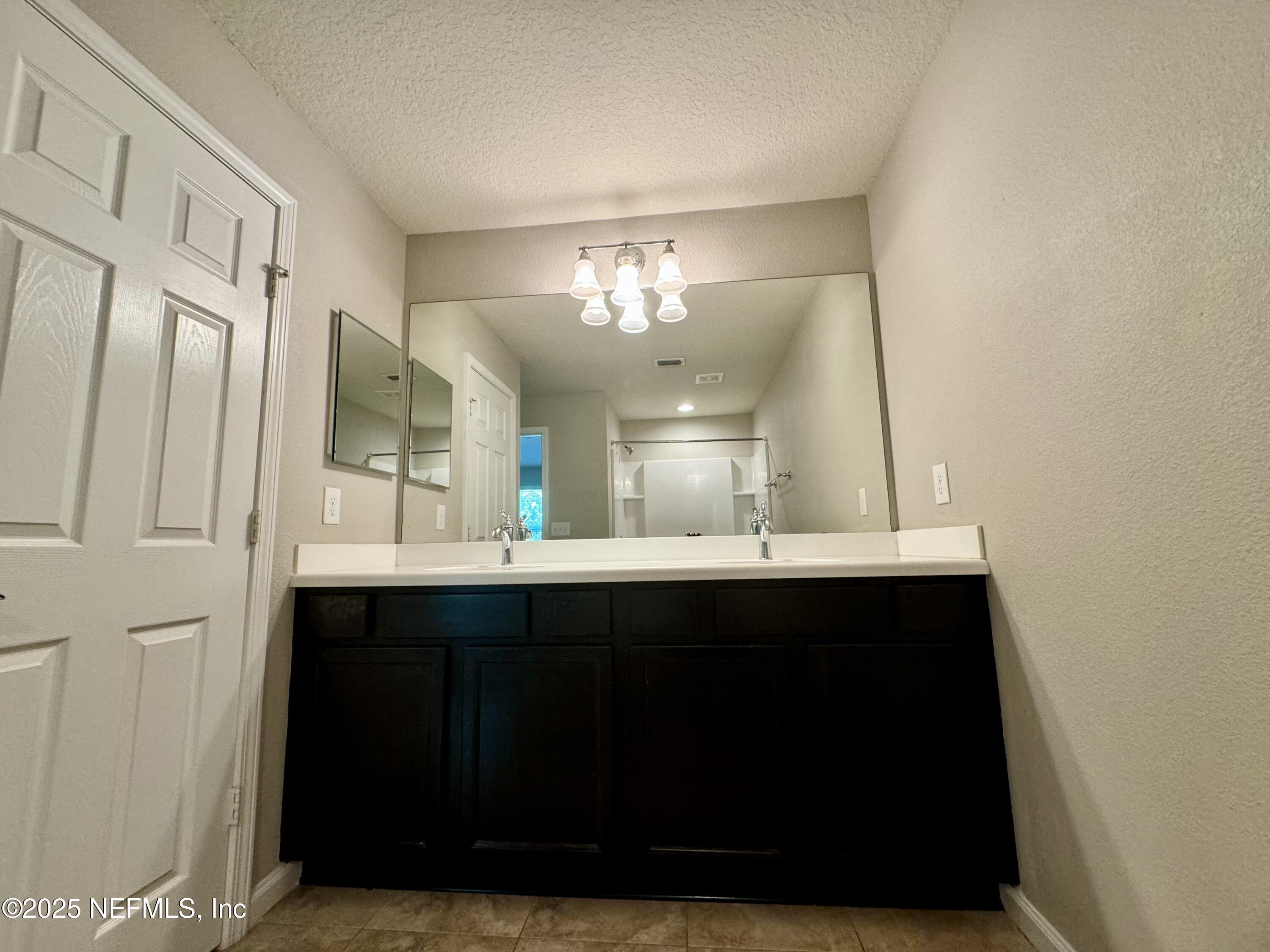 6839 Roundleaf Drive Jacksonville, FL 32258 - Photo 16 of 30 a bathroom with a sink and a mirror