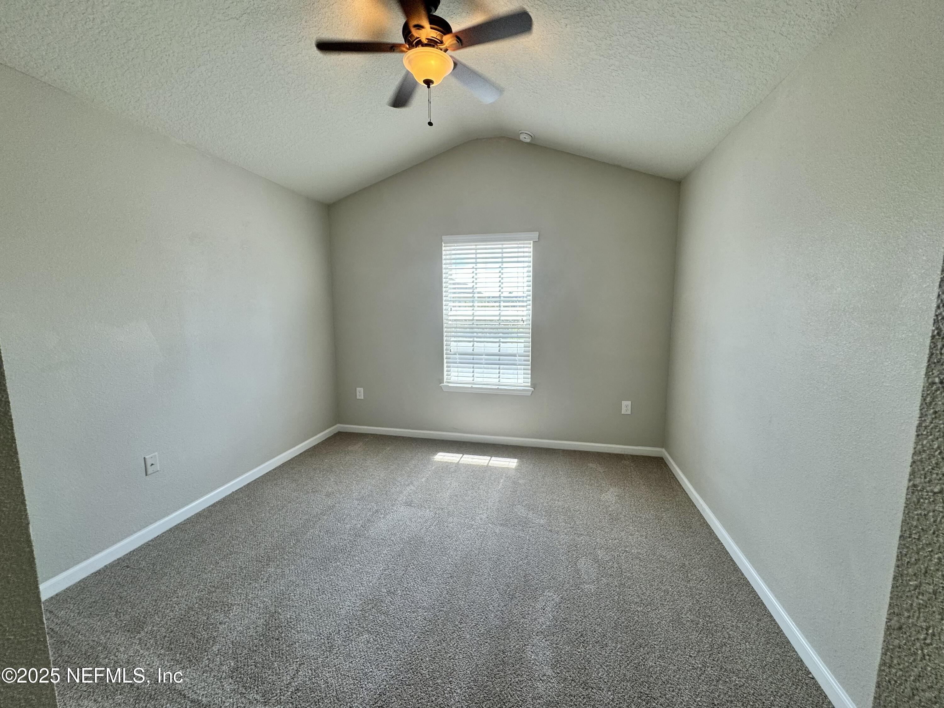 6839 Roundleaf Drive Jacksonville, FL 32258 - Photo 19 of 30 an empty room with a window and a ceiling fan