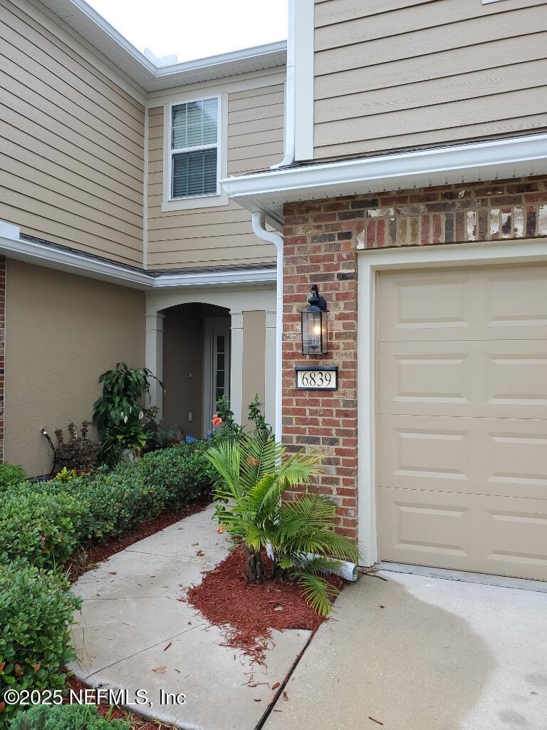 6839 Roundleaf Drive Jacksonville, FL 32258 - Photo 2 of 30 a front view of a house with a garden