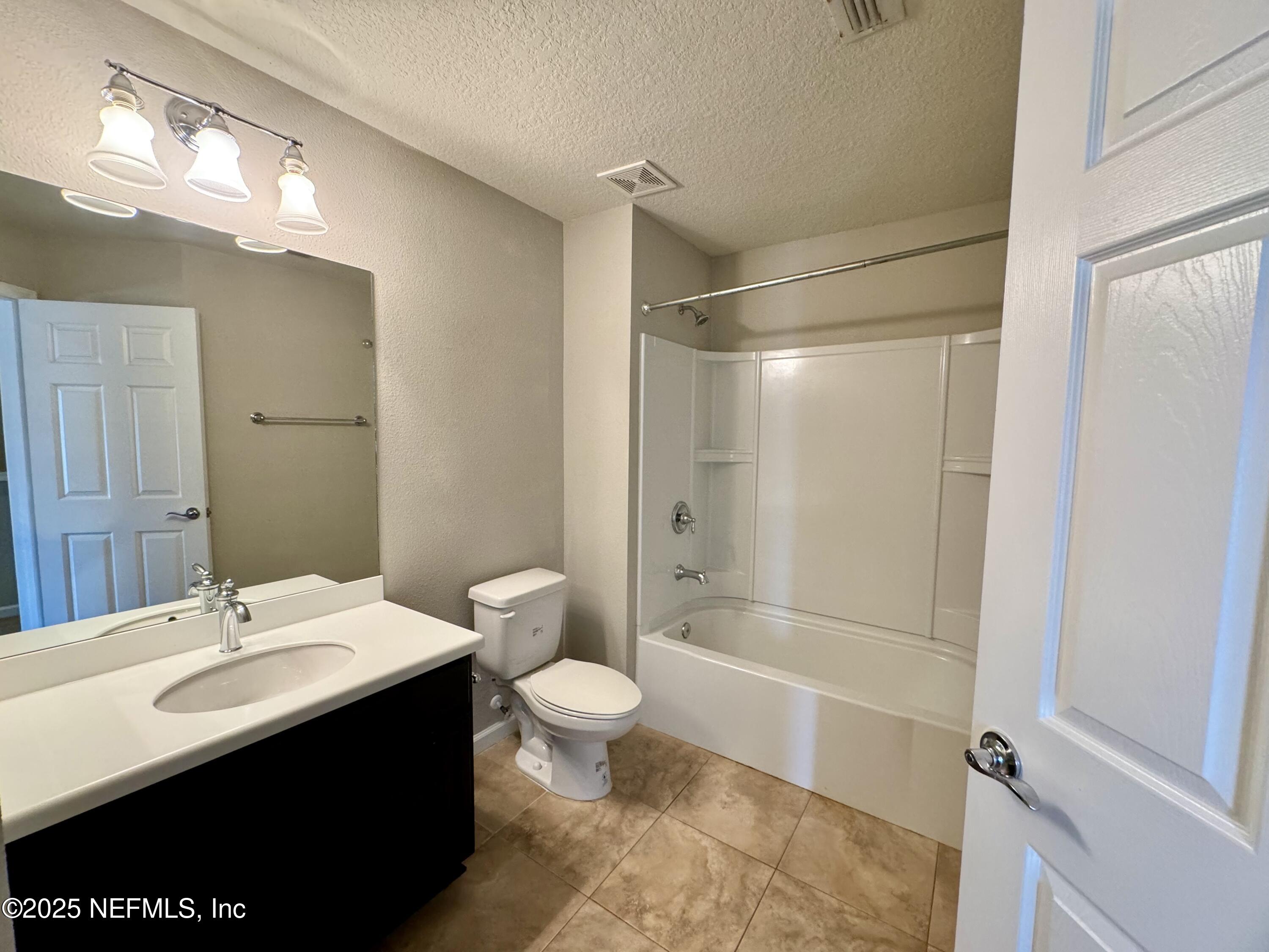 6839 Roundleaf Drive Jacksonville, FL 32258 - Photo 21 of 30 a bathroom with a sink a toilet a shower and a mirror
