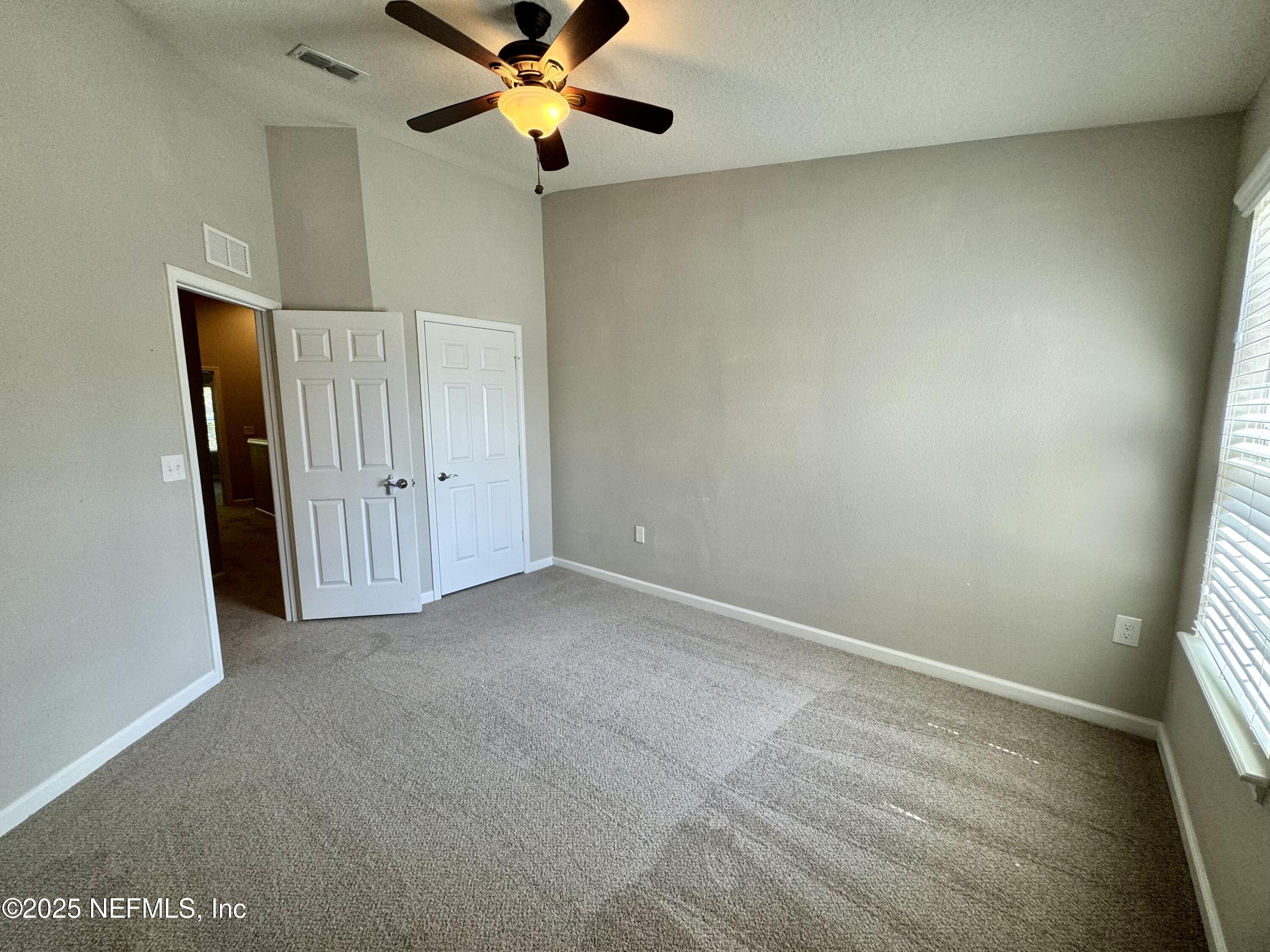 6839 Roundleaf Drive Jacksonville, FL 32258 - Photo 22 of 30 an empty room with a window and a fan