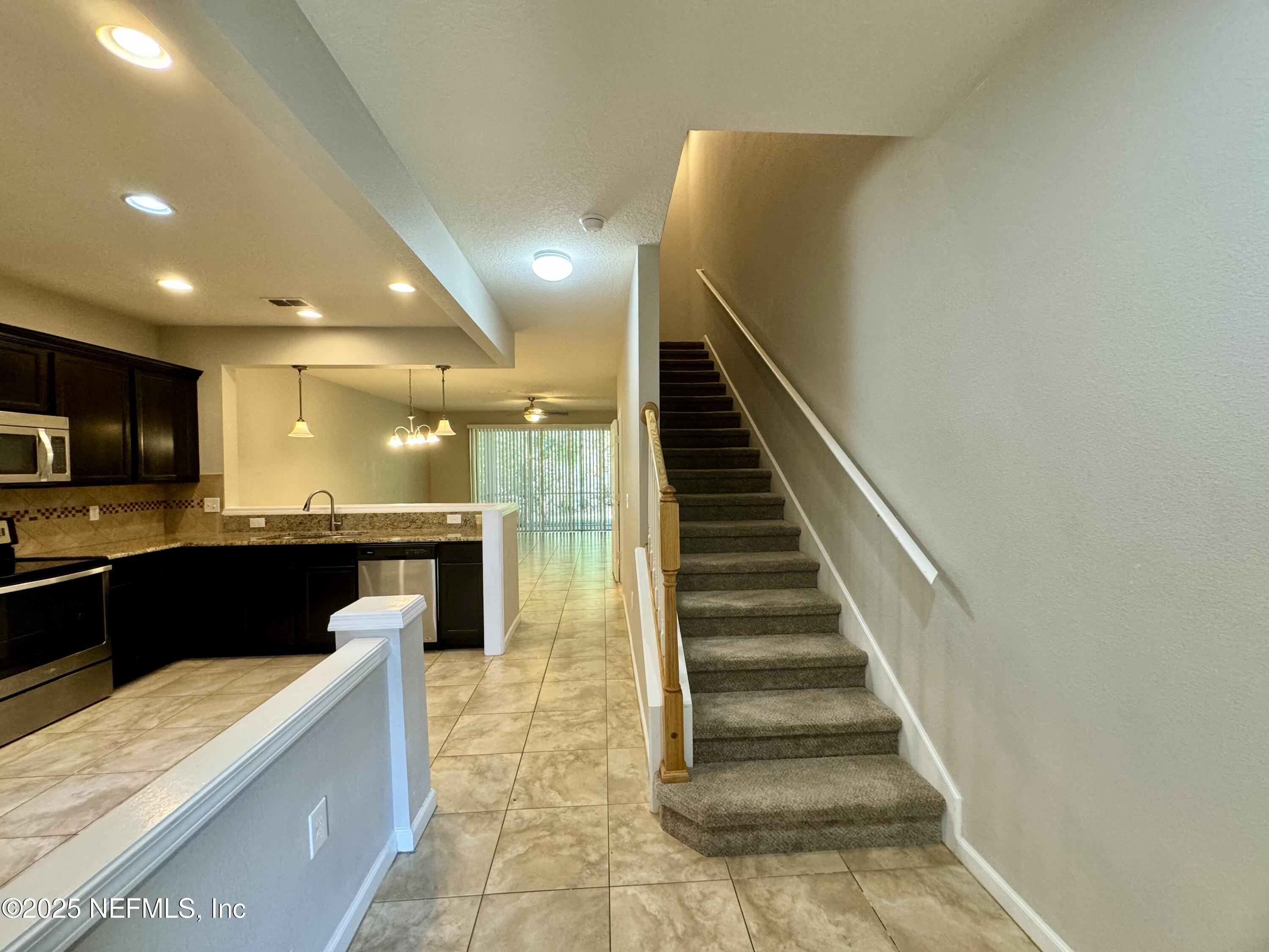 6839 Roundleaf Drive Jacksonville, FL 32258 - Photo 5 of 30 a view of kitchen with kitchen island wooden floor and living room