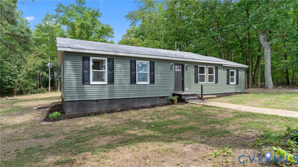 11550 Lunenburg County Road Keysville, VA 23947 - Photo 30 of 48 Siding exterior with dark shutters and a covered e
