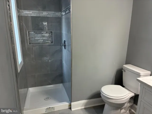 a toilet sitting in a bathroom next to a glass door