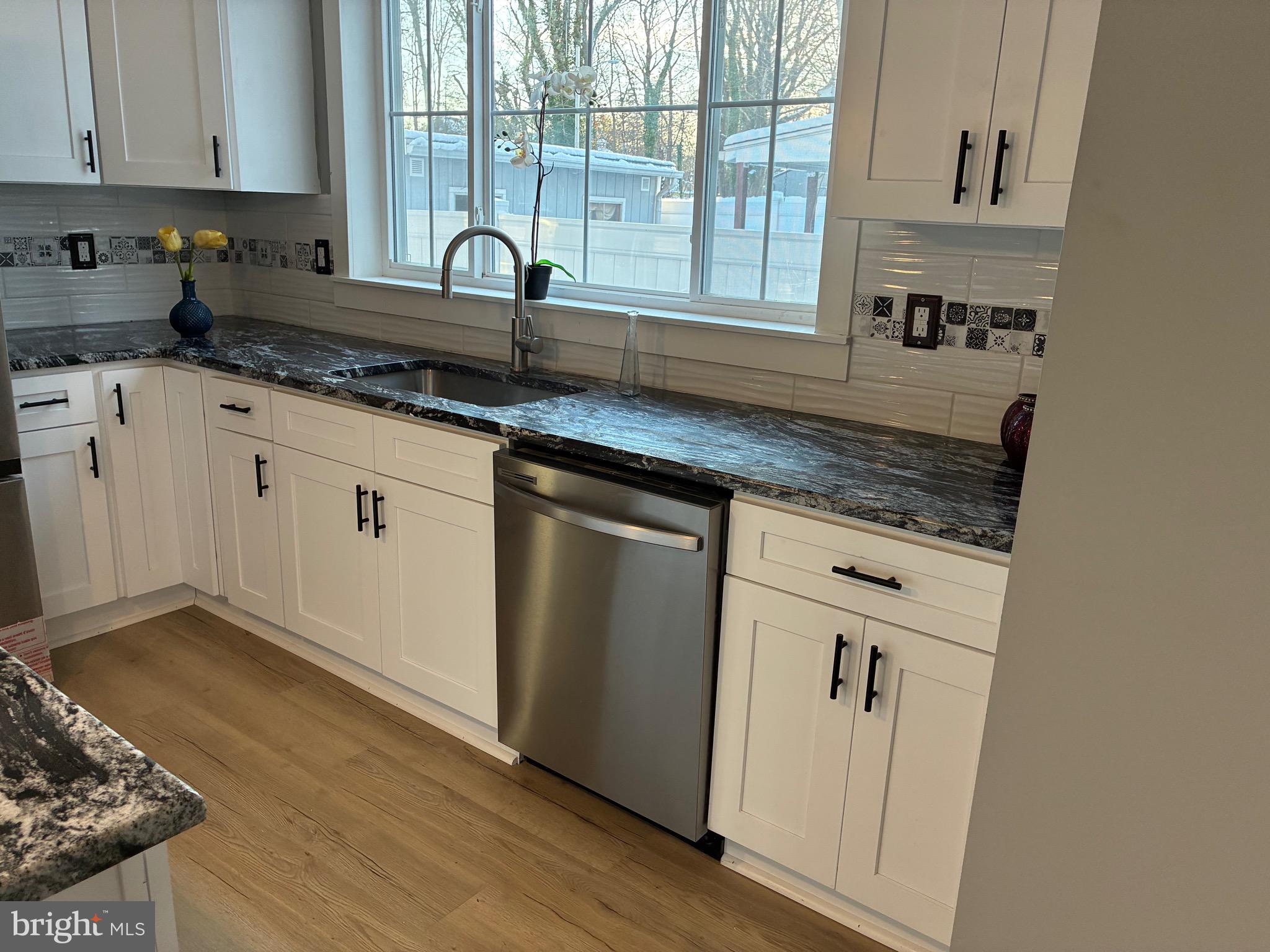 80 East 3rd Street Moorestown, NJ 08057 - Photo 26 of 37 a kitchen with granite countertop white cabinets and window