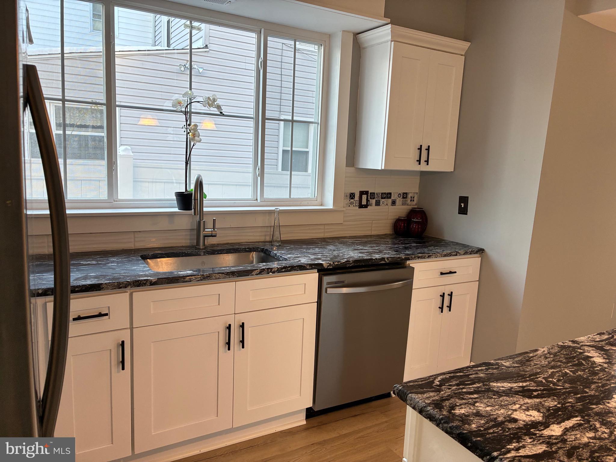 80 East 3rd Street Moorestown, NJ 08057 - Photo 34 of 37 a kitchen with granite countertop white cabinets and a sink