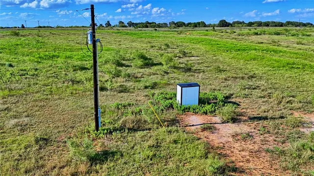 a backyard of a building with trees in the background