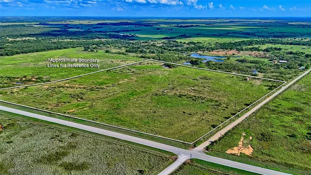 a view of a yard with a wooden fence
