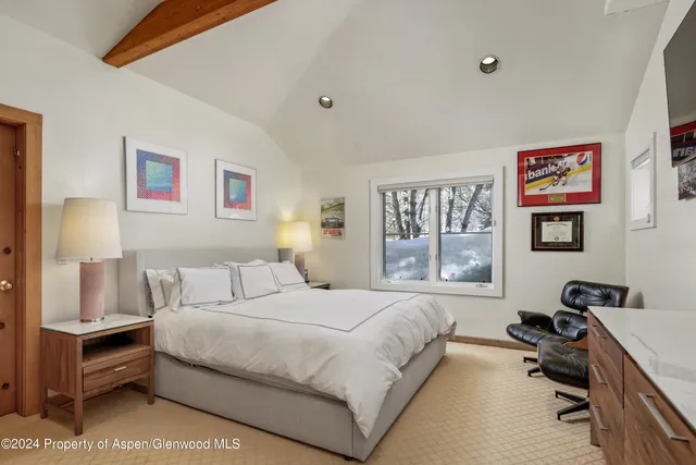 a bedroom with a bed and a desk