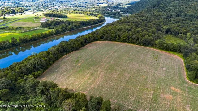 an aerial view of residential houses with outdoor space and swimming pool