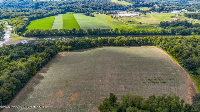 an aerial view of a houses with outdoor space and swimming pool