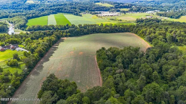 an aerial view of a houses with a lake view