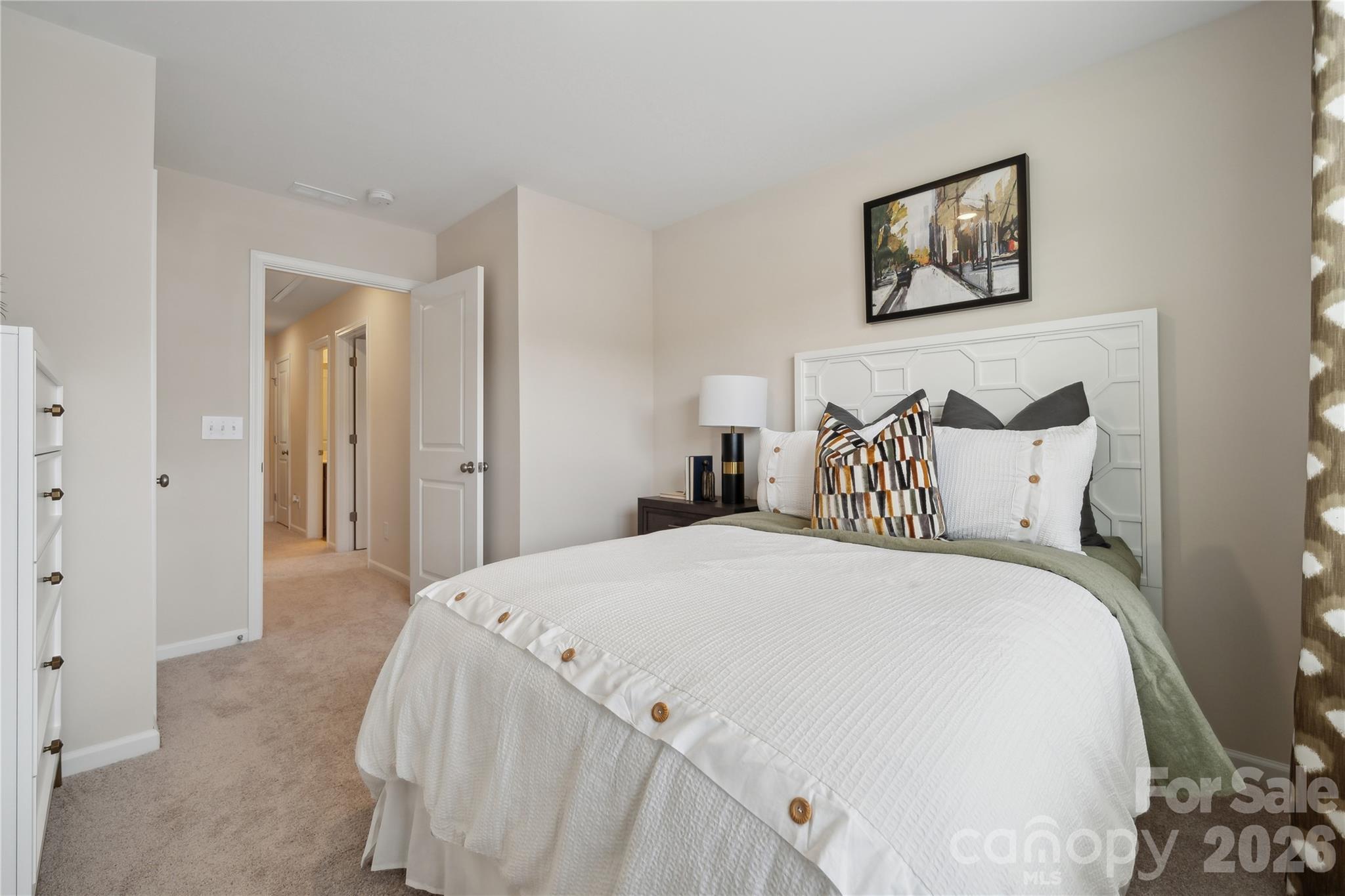 5853 Tuckaseegee Road, Unit 5 Charlotte, NC 28208 - Photo 13 of 24 a large white bed in a white room