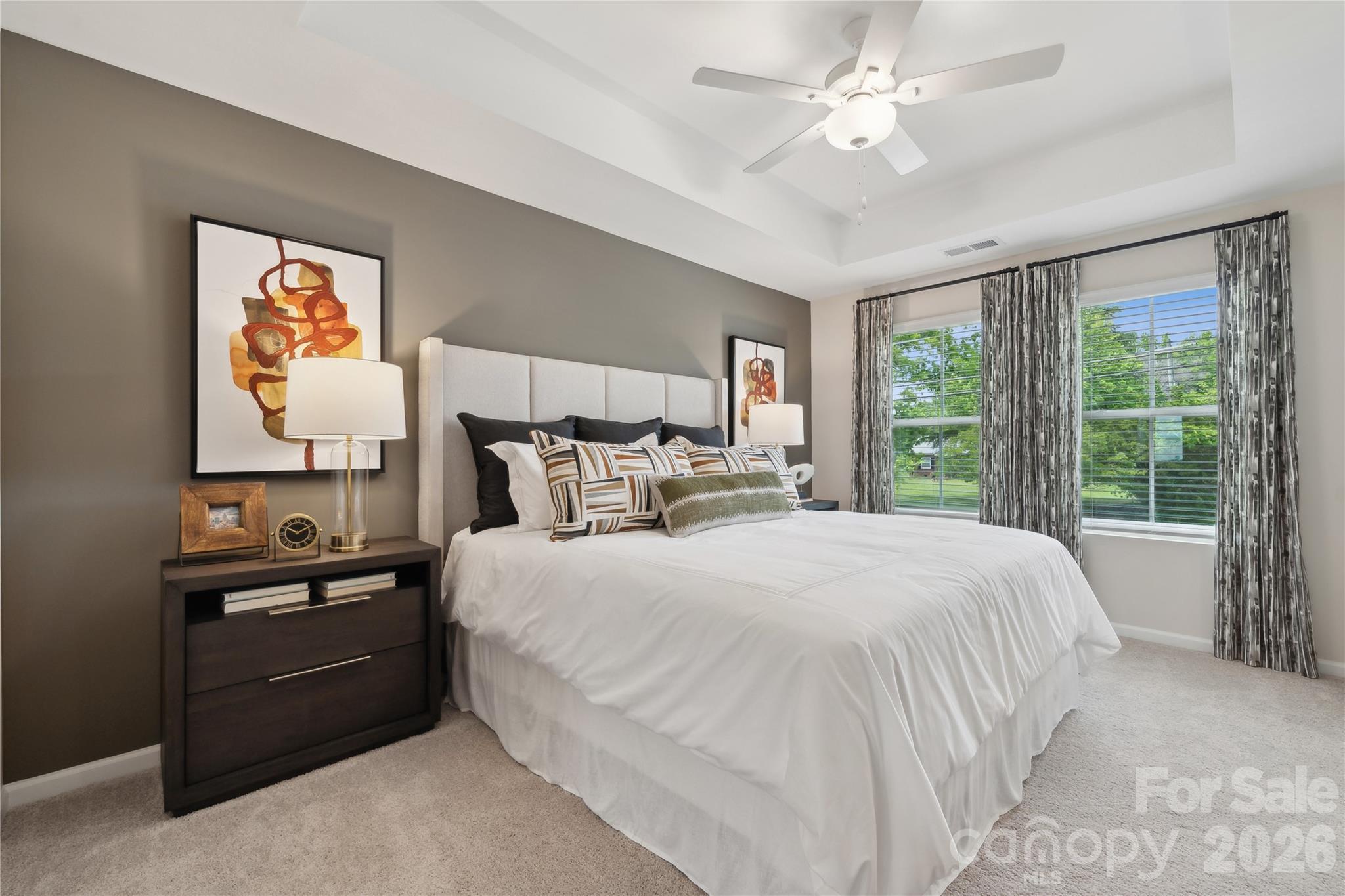 5853 Tuckaseegee Road, Unit 5 Charlotte, NC 28208 - Photo 21 of 24 a bedroom with a bed and a chandelier