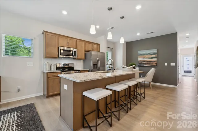 a large kitchen with kitchen island a sink table and chairs
