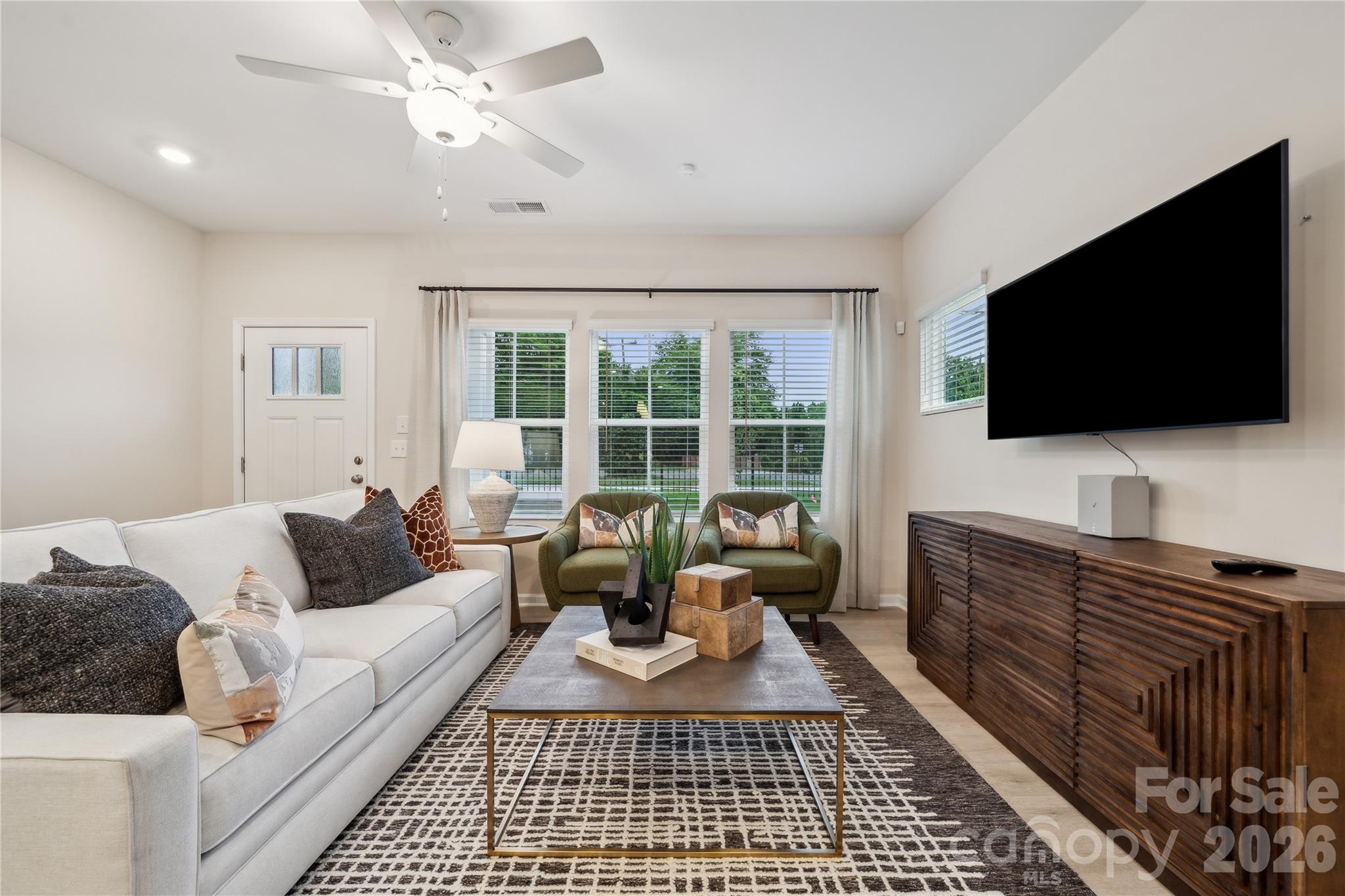 5853 Tuckaseegee Road, Unit 5 Charlotte, NC 28208 - Photo 8 of 24 a living room with furniture and a flat screen tv