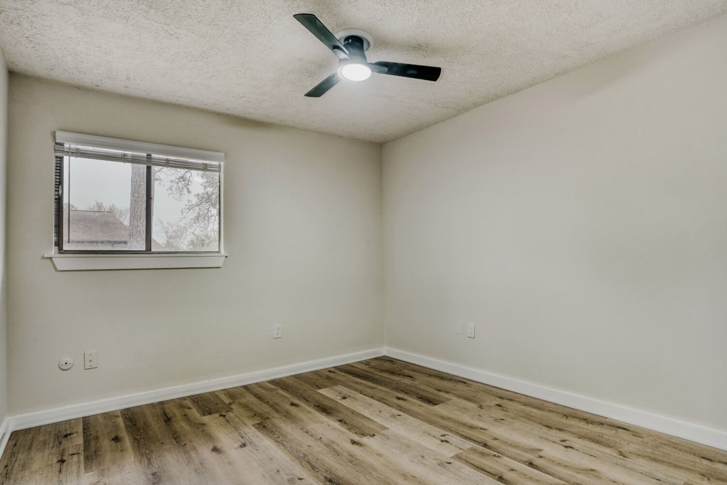 17804 Paddle Wheel Drive Spring, TX 77379 - Photo 14 of 17 an empty room with wooden floor and windows