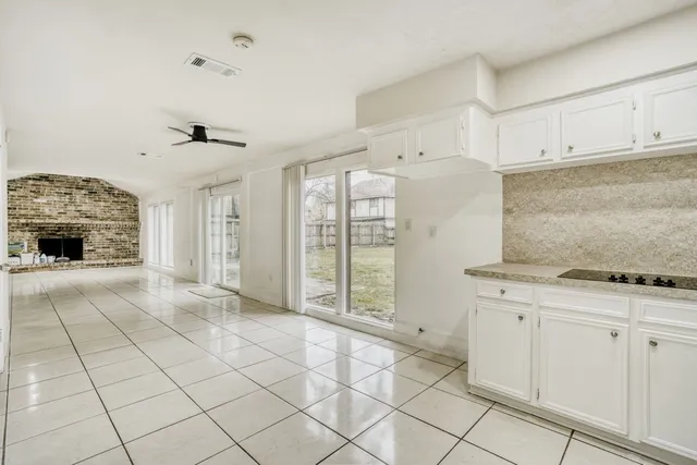 a view of a kitchen with dishwasher and white cabinets