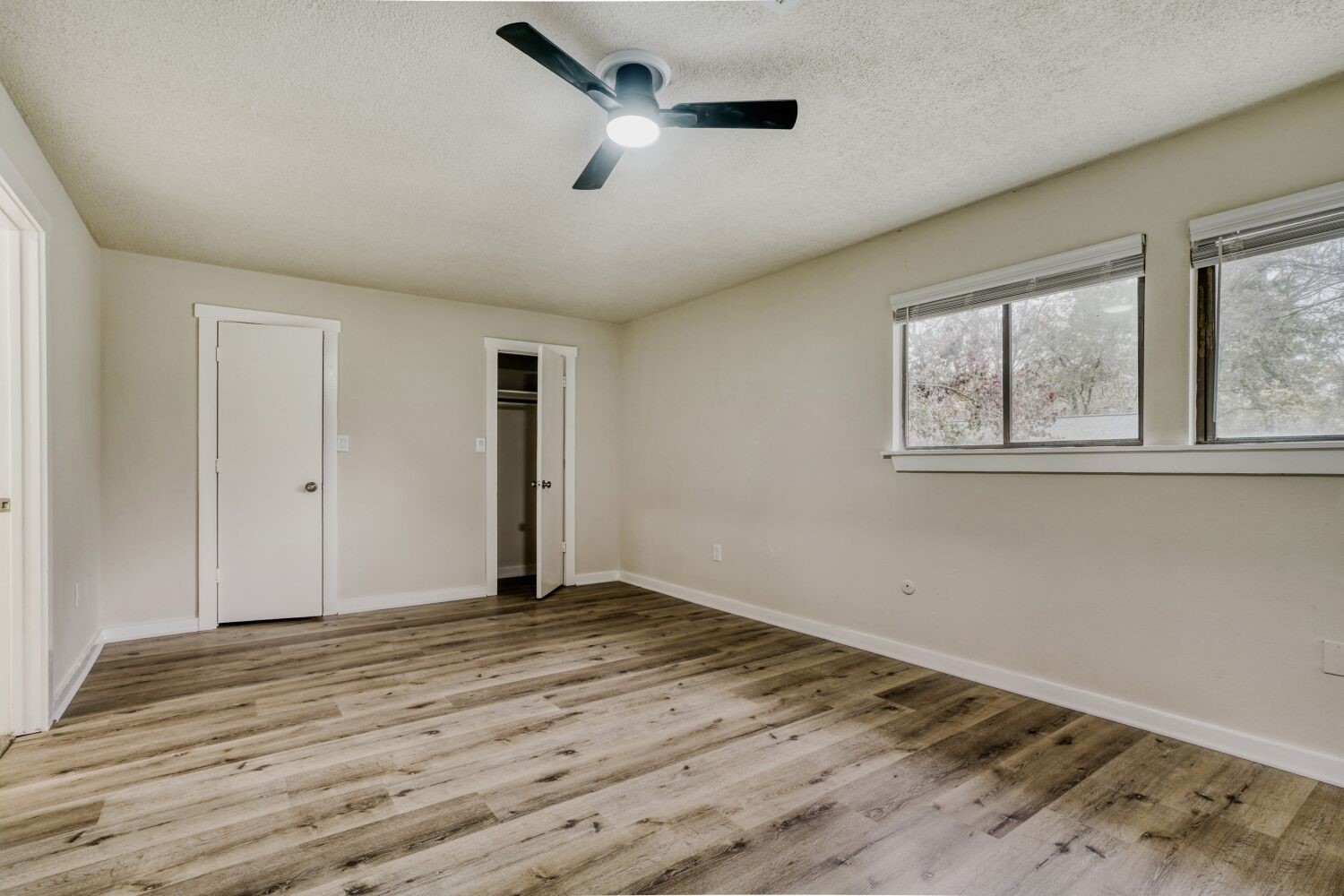 17804 Paddle Wheel Drive Spring, TX 77379 - Photo 10 of 17 an empty room with wooden floor chandelier fan and windows