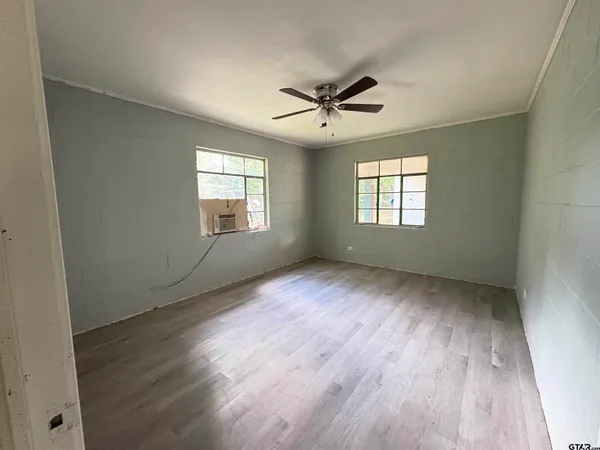 a living room with furniture and large windows