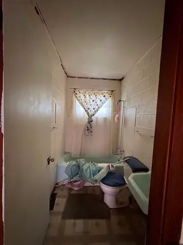 a living room with furniture and a ceiling fan