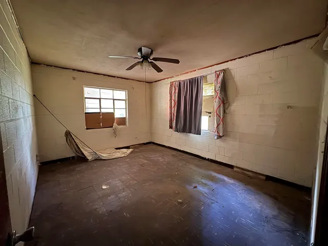 a view of a kitchen with refrigerator and wooden floor