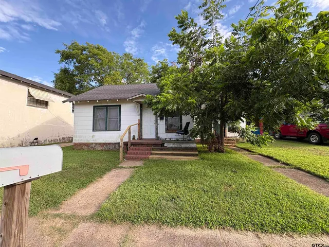 a kitchen with a refrigerator and a sink