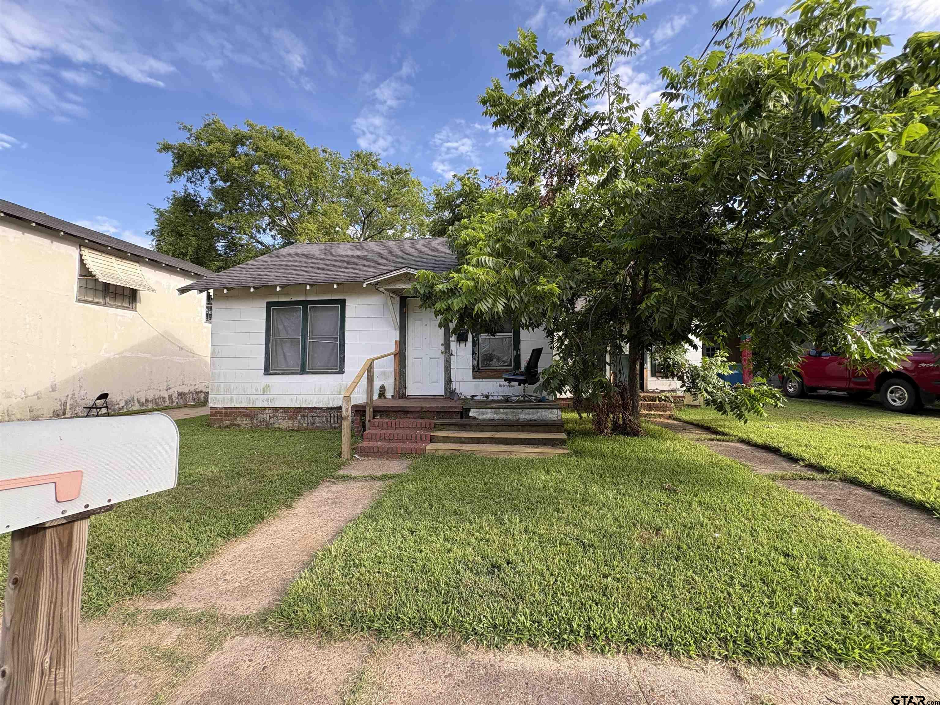 110 East 9th Street Mount Pleasant, TX 75455 - Photo 21 of 27 a view of a house with a yard and sitting area