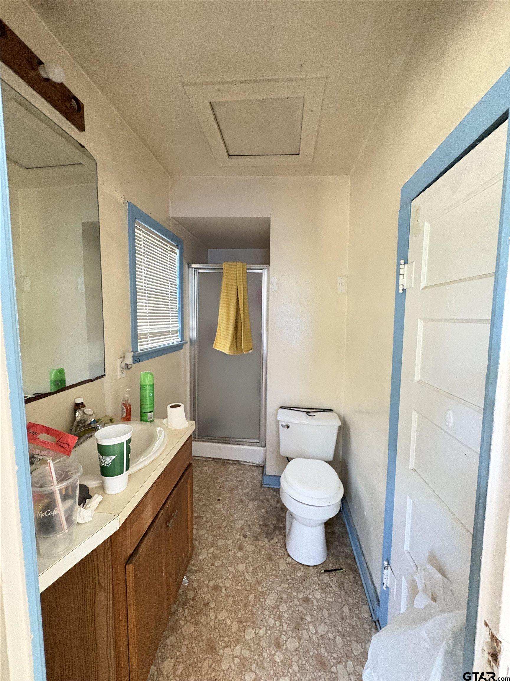 110 East 9th Street Mount Pleasant, TX 75455 - Photo 25 of 27 a bathroom with a sink toilet vanity and tub