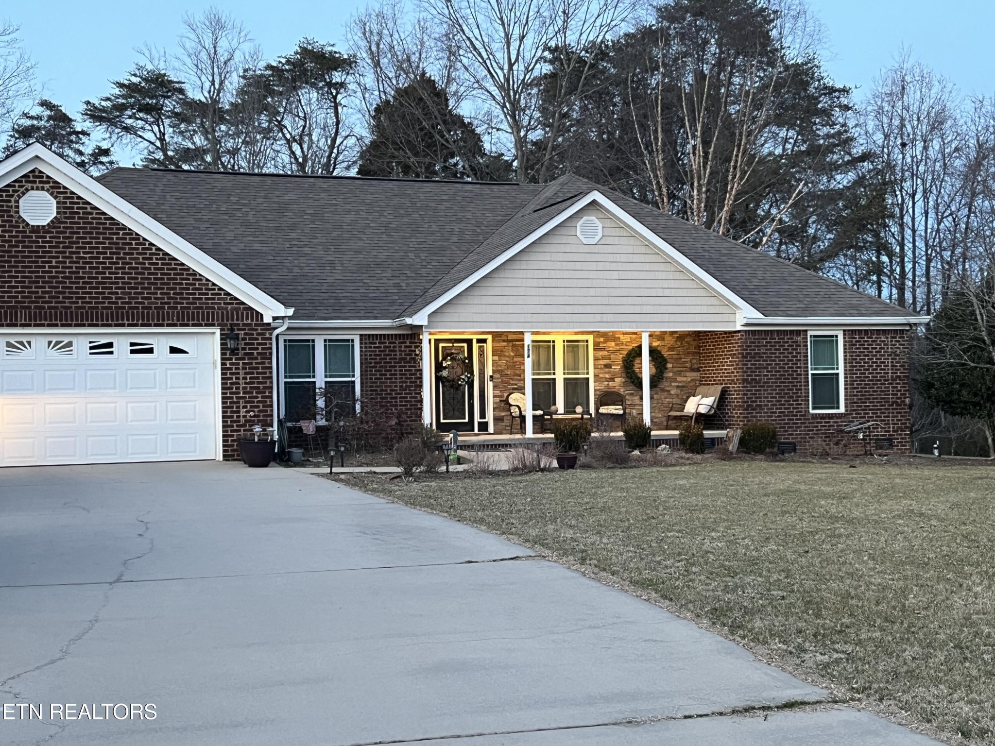 174 Spring Cove Lane Spring City, TN 37381 - Photo 2 of 50 a house with trees in the background