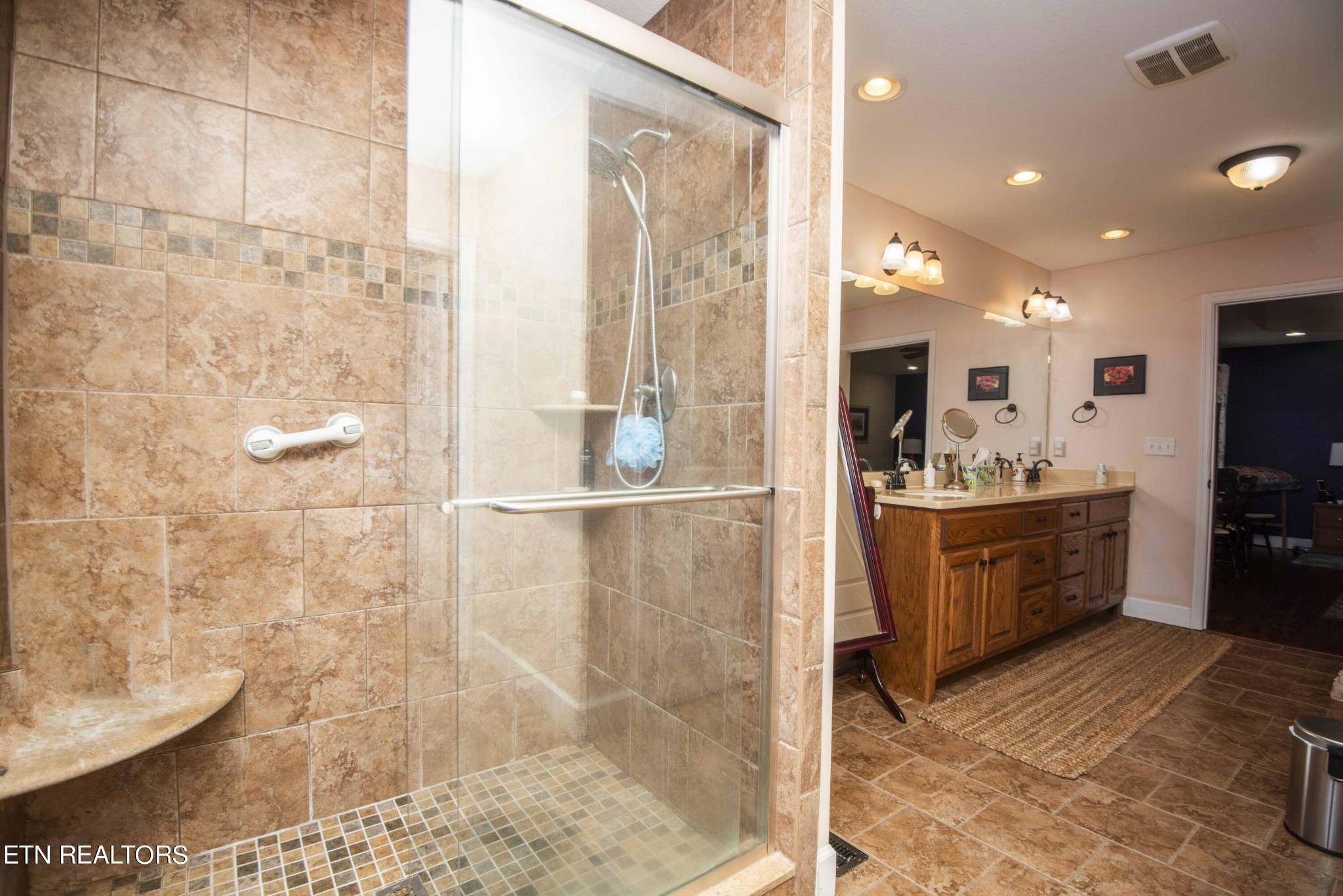 174 Spring Cove Lane Spring City, TN 37381 - Photo 21 of 50 a large bathroom with a double vanity sink a mirror and a shower