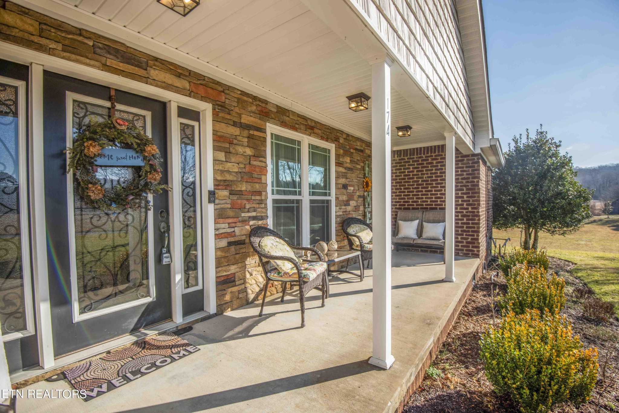 174 Spring Cove Lane Spring City, TN 37381 - Photo 3 of 50 a balcony with table and chairs