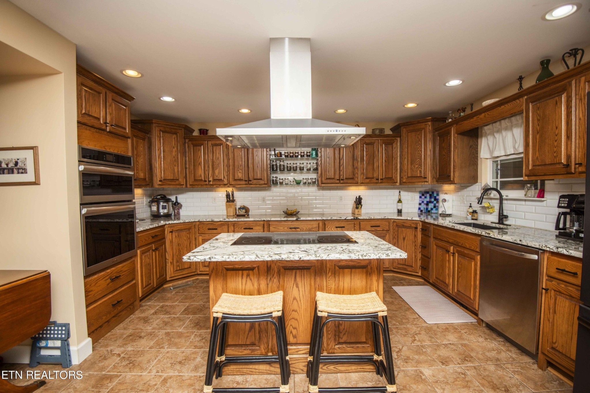 174 Spring Cove Lane Spring City, TN 37381 - Photo 8 of 50 a kitchen with kitchen island granite countertop wooden cabinets and stainless steel appliances