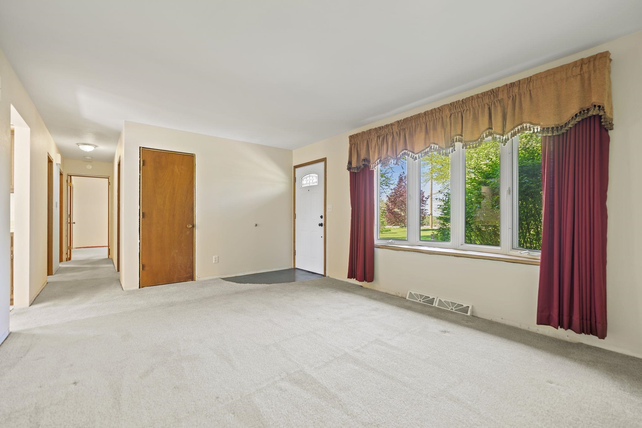 8235 Belvidere Road Caledonia, IL 61011 - Photo 8 of 40 a view of an empty room with a window and doors