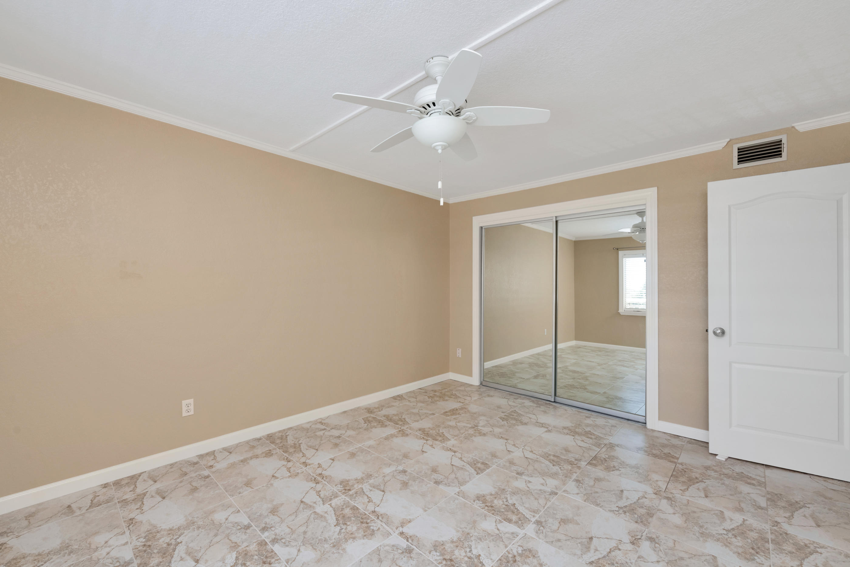 151 Calhoun Avenue, Unit 409 Destin, FL 32541 - Photo 11 of 15 an empty room with a fan & a window